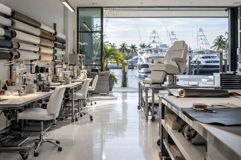 Marine upholstery workshop with a glass door to a yacht marina